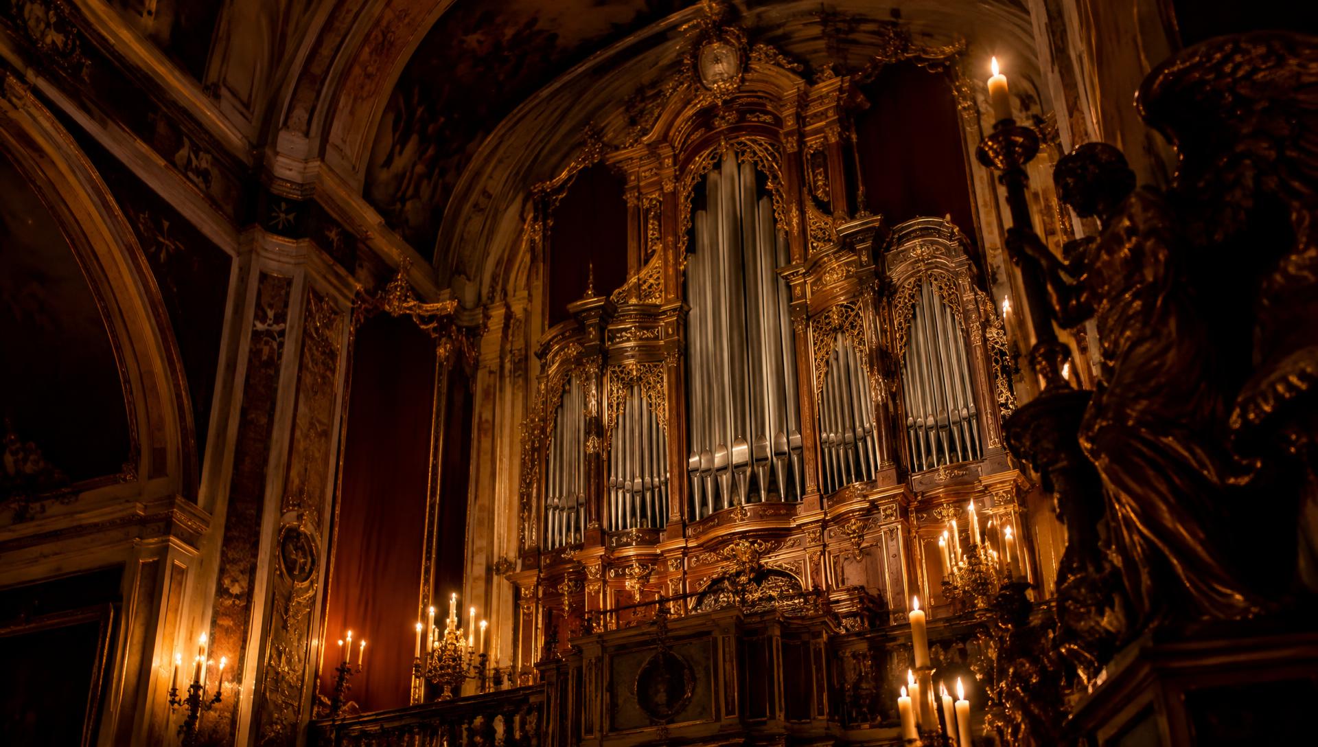 Historic pipe organ in candlelight